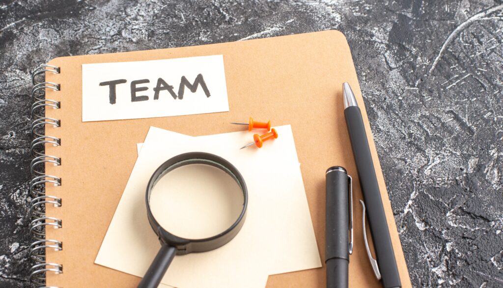 above-view-team-note-attached-to-notepad-with-magn-2023-11-27-04-50-56-utc